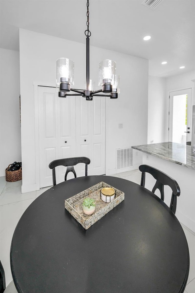 dining area with recessed lighting and a chandelier