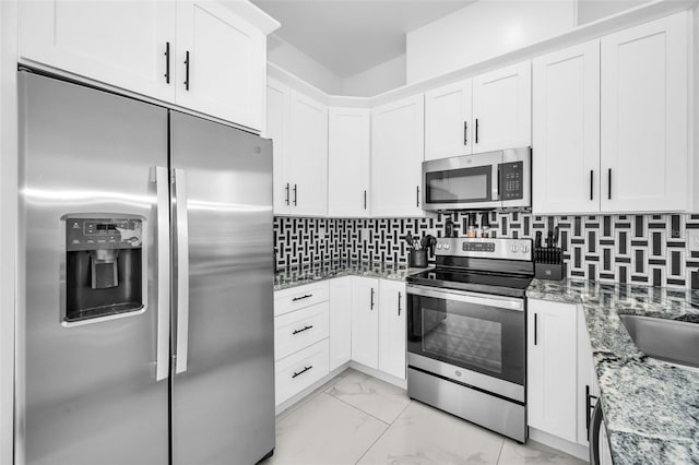 kitchen with stainless steel appliances, light marble finish flooring, light stone countertops, and white cabinetry