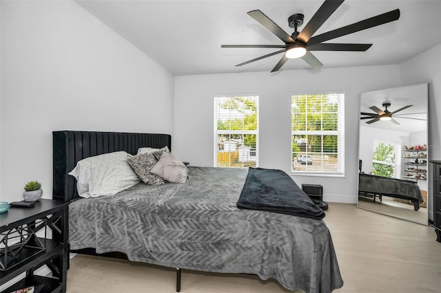 bedroom featuring wood finished floors, ceiling fan, and baseboards