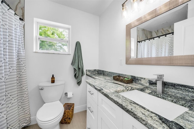 full bathroom with toilet, vanity, wood finished floors, baseboards, and a shower with shower curtain
