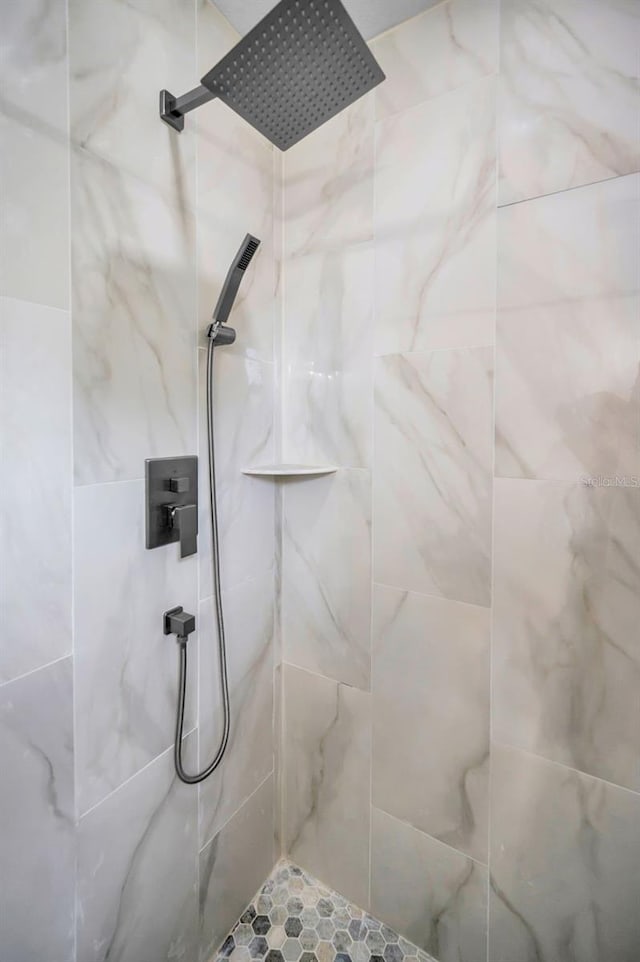bathroom with a tile shower
