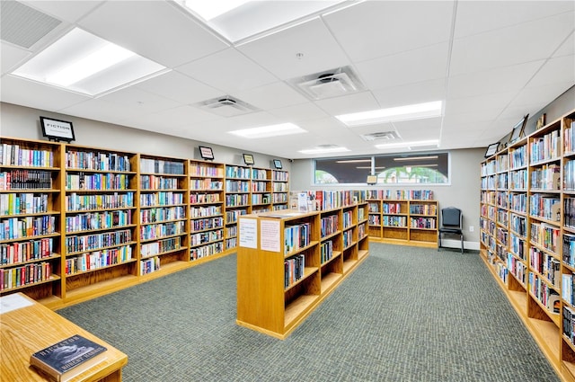 11723 Boynton Ln Unit 1, New Port Richey, FL 34654 - misc room featuring bookshelves, a drop ceiling, and carpet