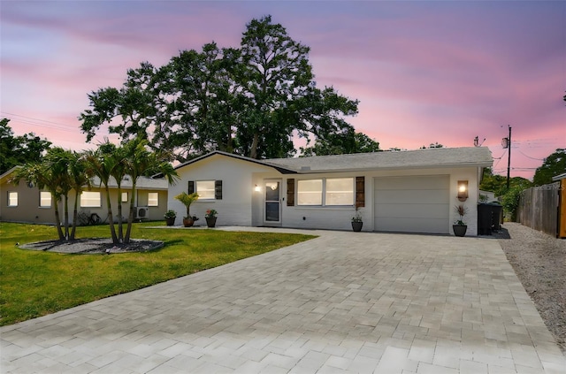 single story home featuring decorative driveway and an attached garage