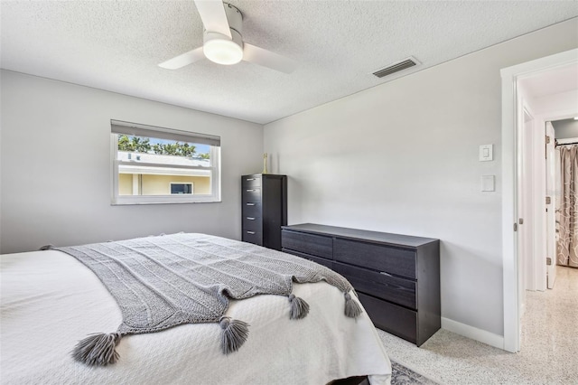 bedroom with a textured ceiling, baseboards, a ceiling fan, and light colored carpet