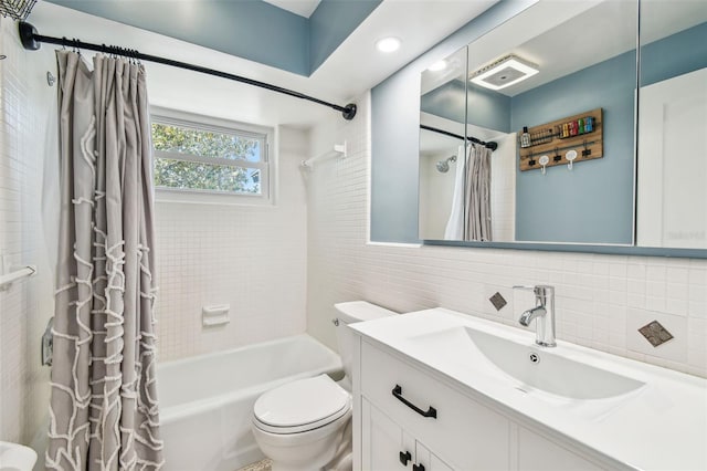bathroom featuring tile walls, toilet, shower / bath combo, and vanity