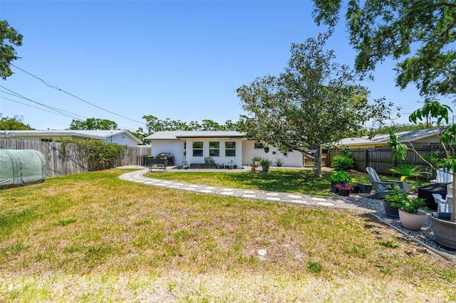 back of property with stucco siding and a patio