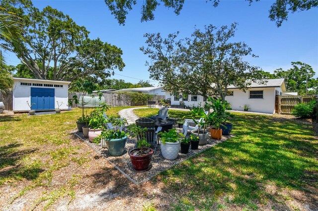 view of yard with a garden, a storage shed, and an outdoor structure