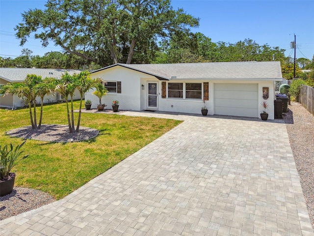 single story home featuring decorative driveway and a garage