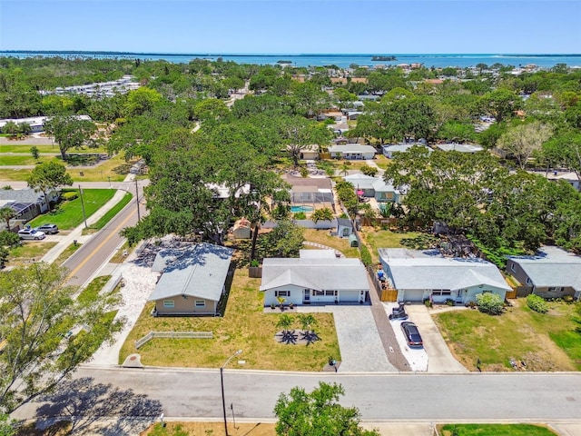 aerial perspective of suburban area with a nearby body of water
