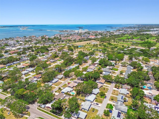 aerial view of property and surrounding area with a nearby body of water and nearby suburban area