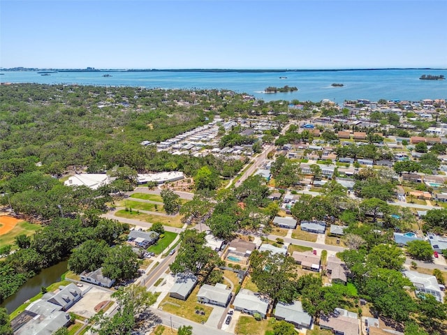 aerial view of property's location with a large body of water and nearby suburban area