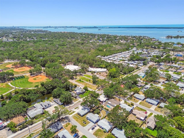 aerial view of property's location with a large body of water and nearby suburban area