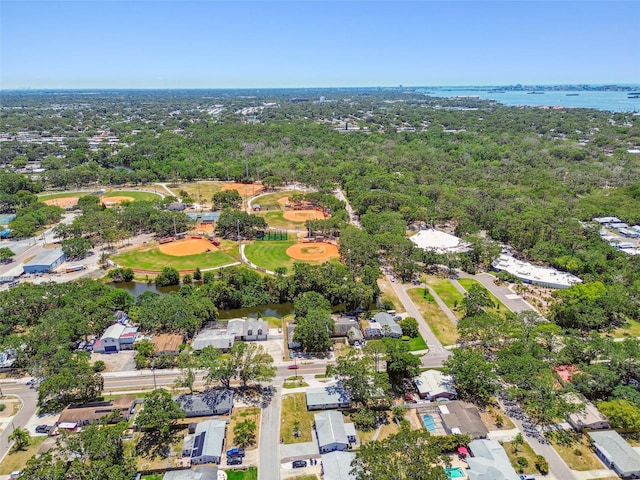 view of property location featuring a nearby body of water and nearby suburban area
