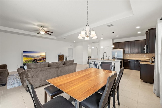 11831 Thicket Wood Dr, Riverview, FL 33579 - dining room with a chandelier, light tile patterned floors, a raised ceiling, ceiling fan, and recessed lighting
