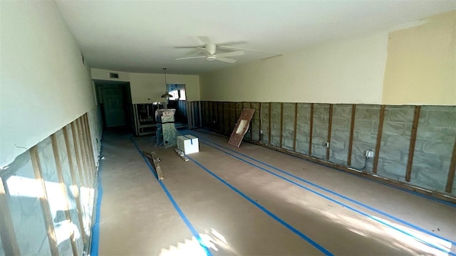 interior space with visible vents and ceiling fan