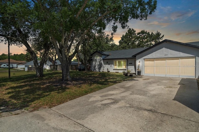 12493 Fish Cove Dr, Spring Hill, FL 34609 - ranch-style home with driveway, a garage, and a lawn