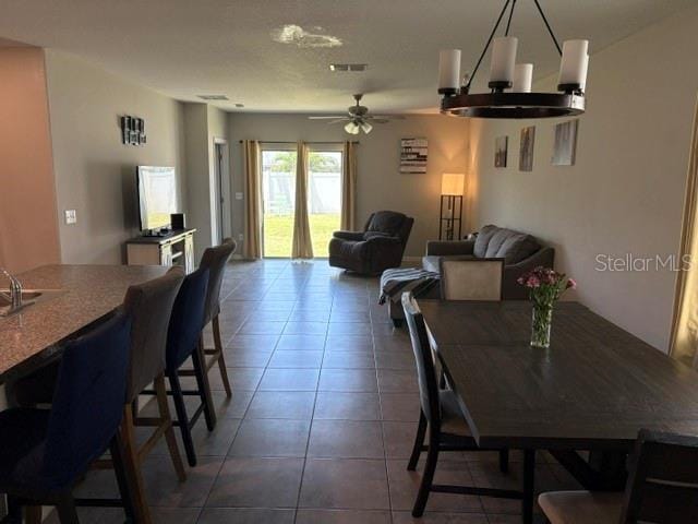 dining room with tile patterned floors, visible vents, and ceiling fan