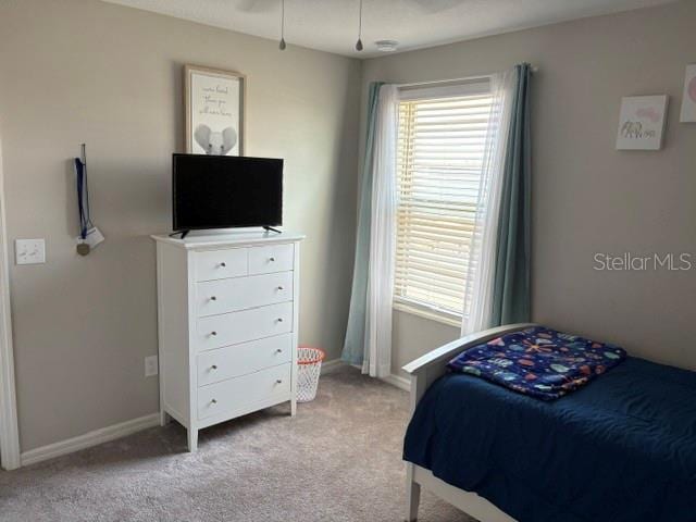 bedroom featuring carpet flooring and baseboards