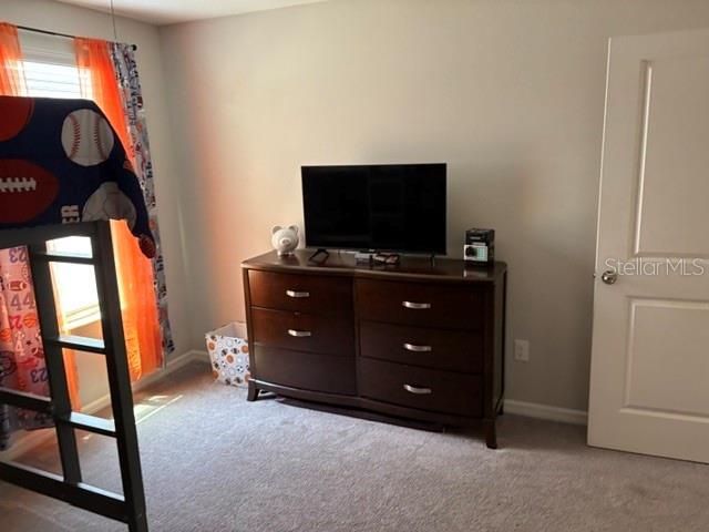 carpeted bedroom with baseboards