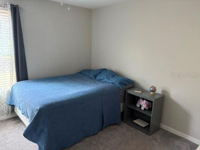 carpeted bedroom with baseboards