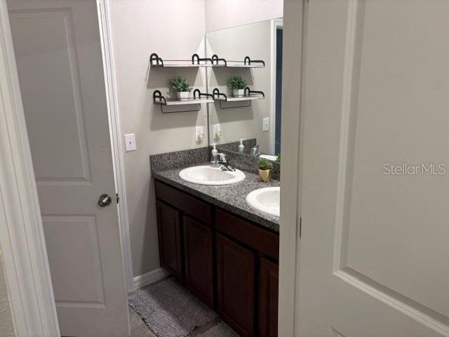 bathroom with a sink and double vanity