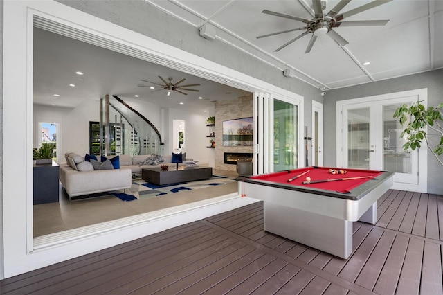 5500 W Lake Butler Rd, Windermere, FL 34786 - playroom with a ceiling fan, a large fireplace, french doors, wood-type flooring, and recessed lighting