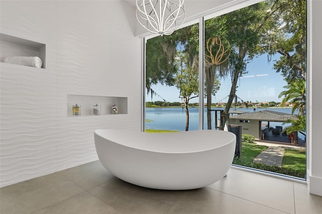5500 W Lake Butler Rd, Windermere, FL 34786 - full bath featuring a chandelier, a water view, a freestanding tub, and tile patterned flooring