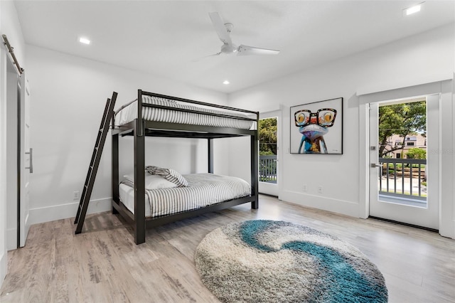 5500 W Lake Butler Rd, Windermere, FL 34786 - bedroom with access to exterior, wood finished floors, a barn door, baseboards, and recessed lighting