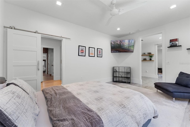 5500 W Lake Butler Rd, Windermere, FL 34786 - bedroom featuring a barn door, light wood finished floors, recessed lighting, baseboards, and ceiling fan