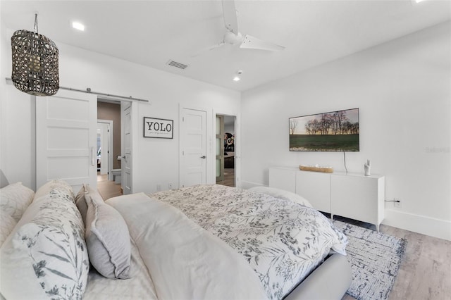5500 W Lake Butler Rd, Windermere, FL 34786 - bedroom featuring a barn door, light wood-style floors, baseboards, recessed lighting, and ceiling fan