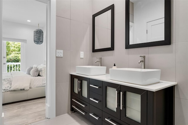 5500 W Lake Butler Rd, Windermere, FL 34786 - full bathroom with connected bathroom, double vanity, and tile walls
