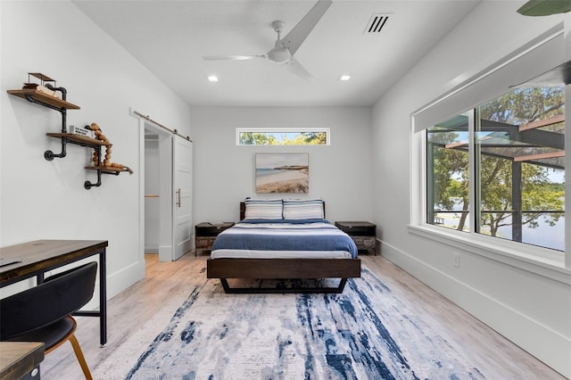 5500 W Lake Butler Rd, Windermere, FL 34786 - bedroom with a barn door, light wood finished floors, baseboards, recessed lighting, and ceiling fan