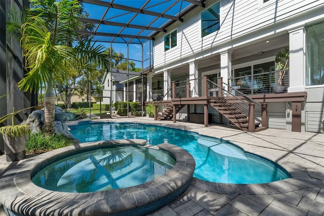5500 W Lake Butler Rd, Windermere, FL 34786 - view of swimming pool featuring stairway, a pool with connected hot tub, a patio, and glass enclosure