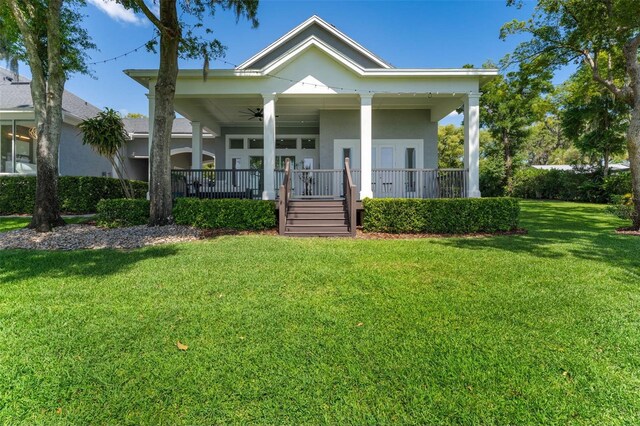 5500 W Lake Butler Rd, Windermere, FL 34786 - view of front of house with ceiling fan, a porch, and a front yard