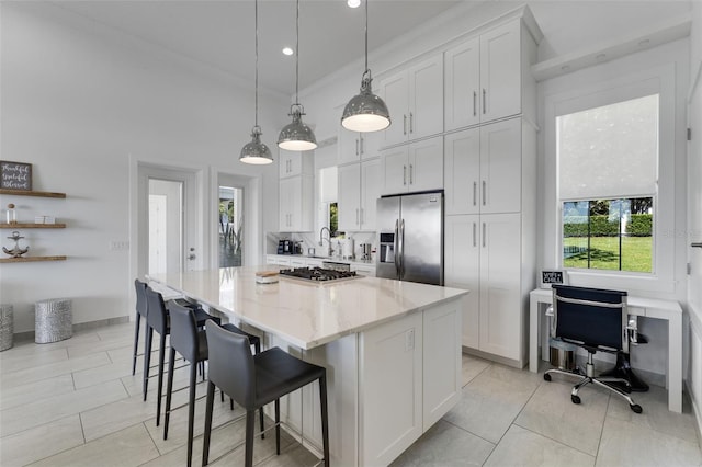5500 W Lake Butler Rd, Windermere, FL 34786 - kitchen with stainless steel appliances, a spacious island, white cabinetry, plenty of natural light, and recessed lighting
