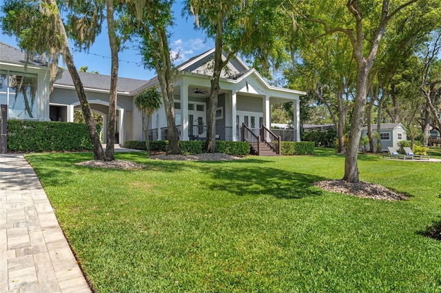 5500 W Lake Butler Rd, Windermere, FL 34786 - view of front facade with ceiling fan, covered porch, a front yard, stucco siding, and french doors