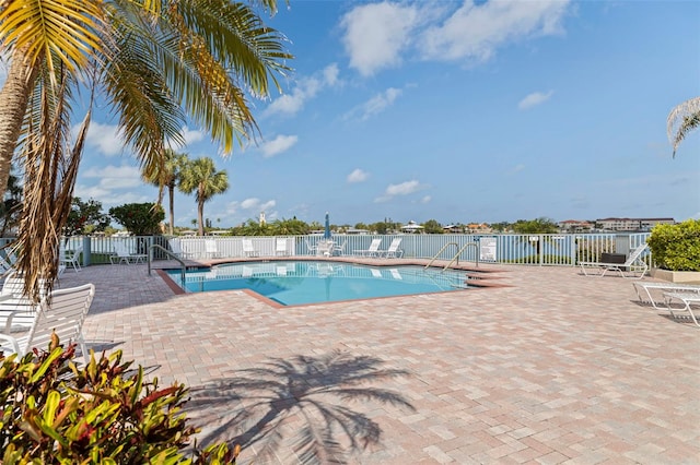 community pool featuring fence and a patio area