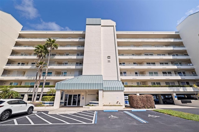 view of apartment building / complex featuring uncovered parking