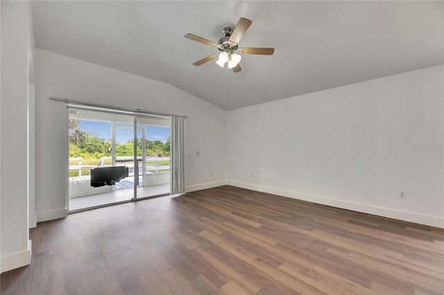 spare room featuring vaulted ceiling, ceiling fan, wood finished floors, and baseboards