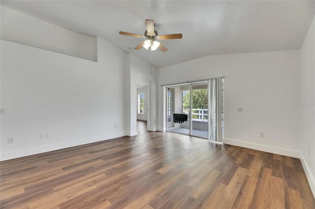 spare room featuring vaulted ceiling, a ceiling fan, baseboards, and wood finished floors