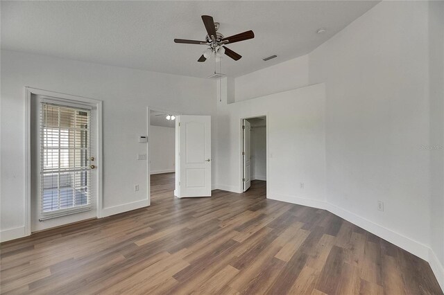 unfurnished bedroom with wood finished floors, baseboards, access to exterior, ceiling fan, and lofted ceiling