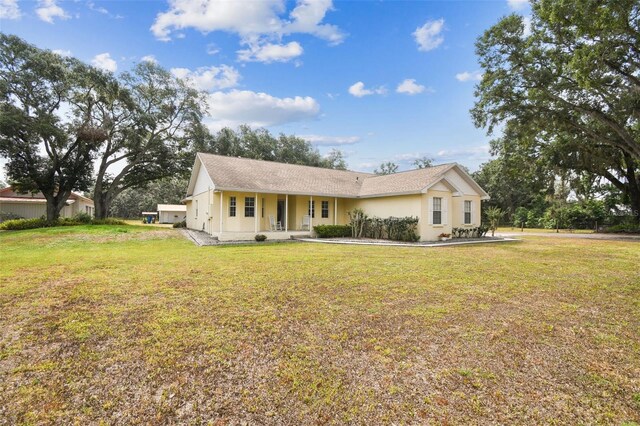 1202 Williams Rd, Plant City, FL 33565 - ranch-style home with covered porch, a front lawn, and stucco siding