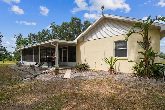 1202 Williams Rd, Plant City, FL 33565 - rear view of property featuring a sunroom and stucco siding