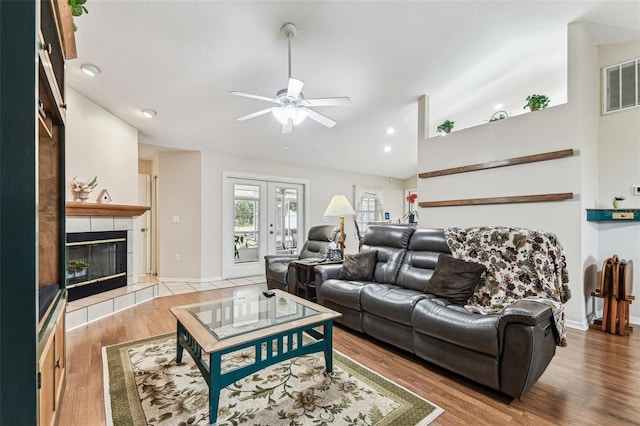 1202 Williams Rd, Plant City, FL 33565 - living room with a ceiling fan, vaulted ceiling, a fireplace, wood finished floors, and baseboards
