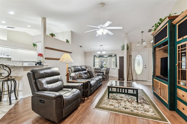 1202 Williams Rd, Plant City, FL 33565 - living room with light wood-type flooring, vaulted ceiling, a ceiling fan, and recessed lighting