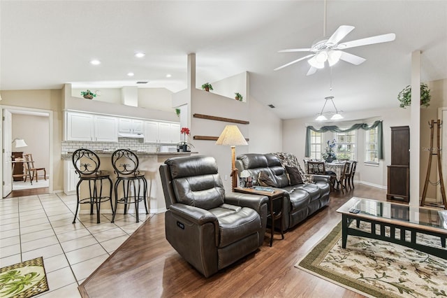 1202 Williams Rd, Plant City, FL 33565 - living area featuring vaulted ceiling, a ceiling fan, and light wood-style floors