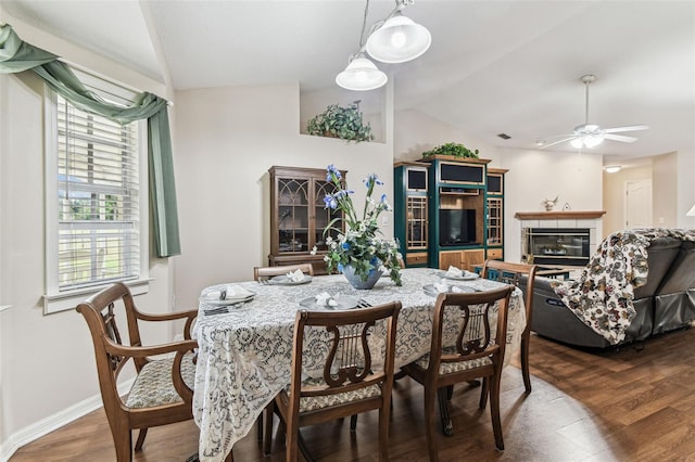 1202 Williams Rd, Plant City, FL 33565 - dining space with lofted ceiling, dark wood-style floors, a ceiling fan, a fireplace, and baseboards
