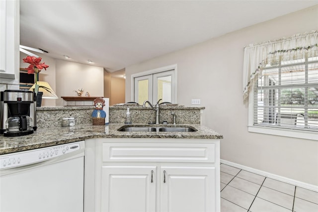 1202 Williams Rd, Plant City, FL 33565 - kitchen featuring white dishwasher, a sink, light tile patterned flooring, white cabinets, and stone countertops