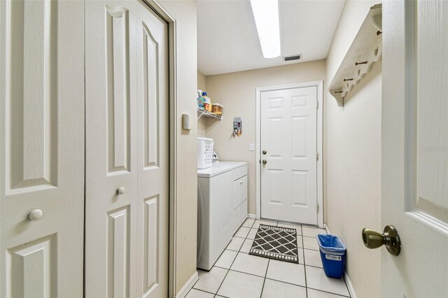 1202 Williams Rd, Plant City, FL 33565 - laundry room with separate washer and dryer, light tile patterned floors, and baseboards
