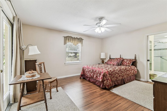1202 Williams Rd, Plant City, FL 33565 - bedroom featuring wood finished floors, baseboards, a textured ceiling, and a ceiling fan